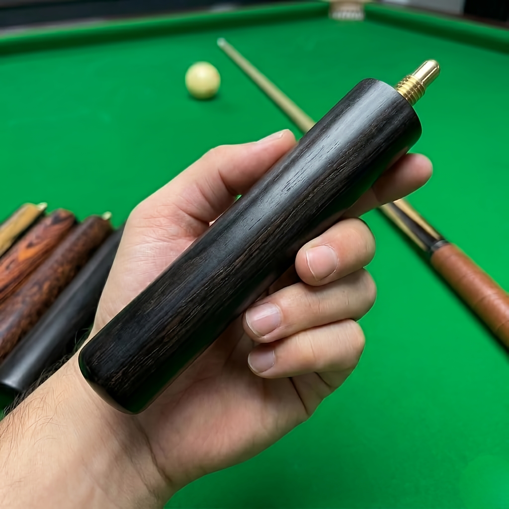 Black screw-on cue extension held above a green billiards table